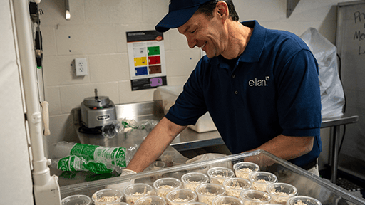 Volunteer prepares food.