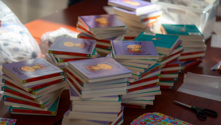 Stacks of brightly colored potty training children's books on a table. 